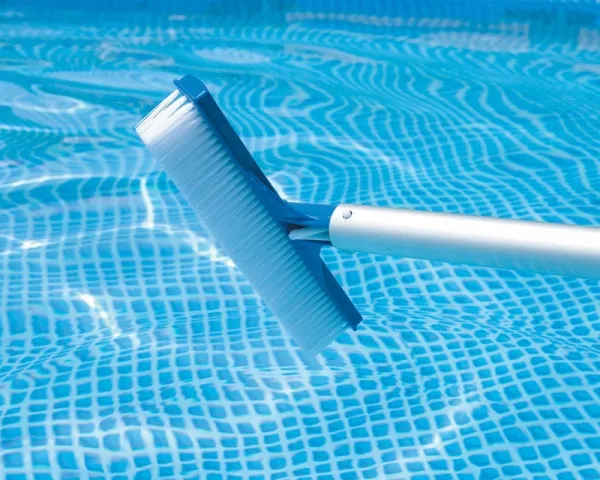 A pool brush cleaning the floor of a pool
