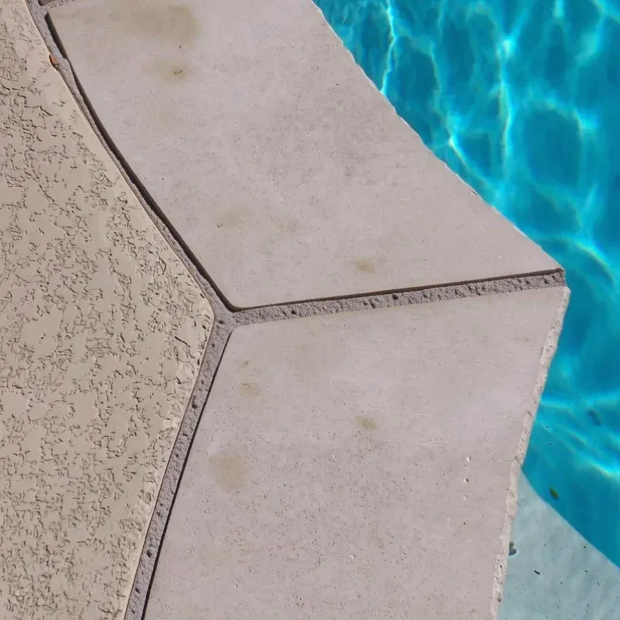 The joint between a pool coping and the deck
