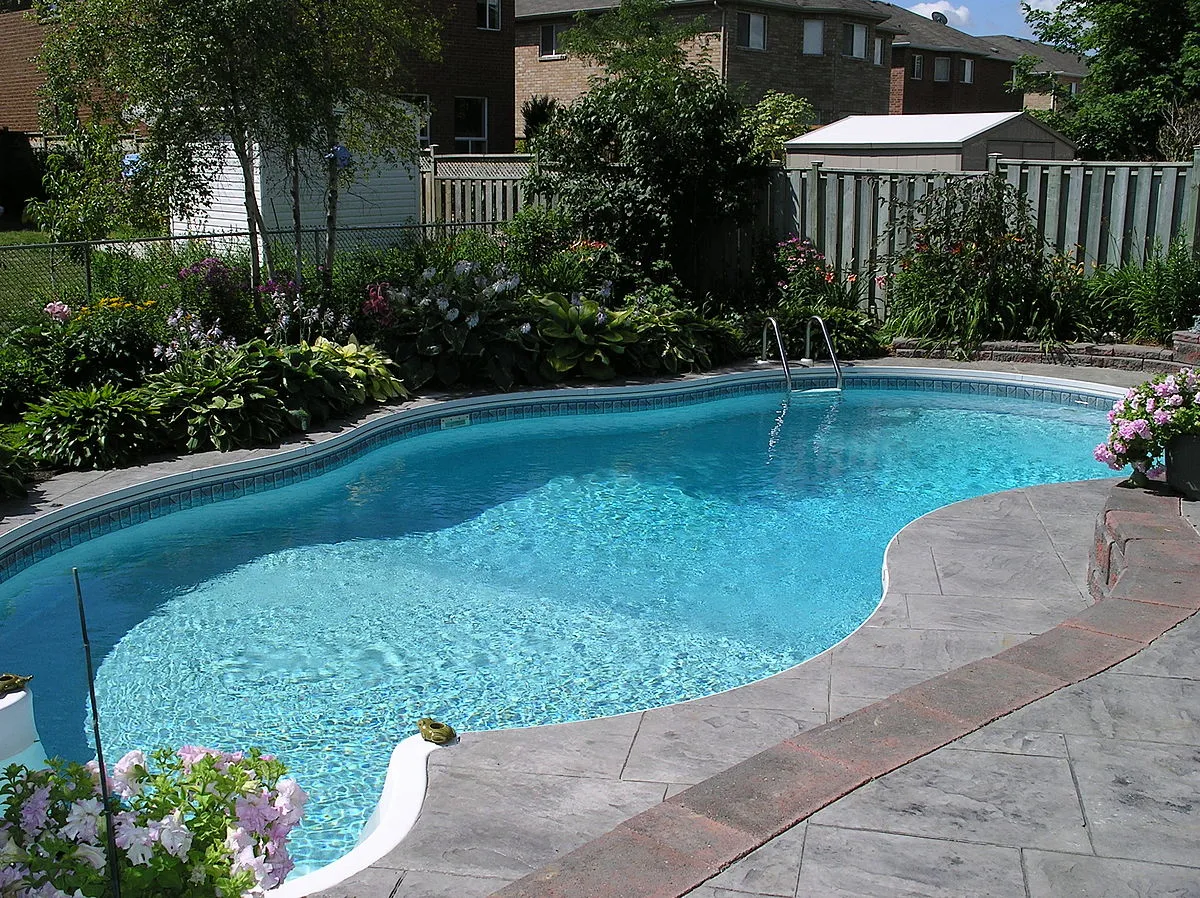 A clean backyard pool with clear blue water