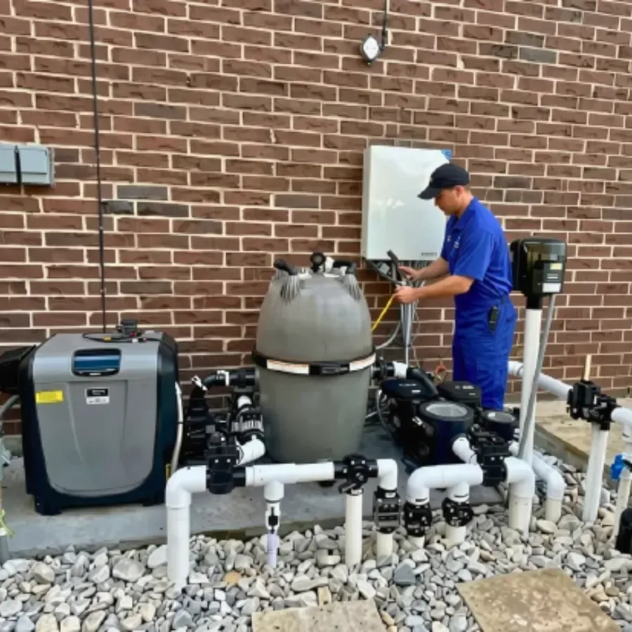 A pool technician working on an equipment pad